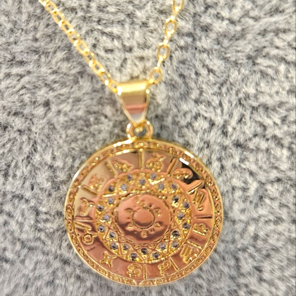Gold filled zodiac seal with the sun in the middle 18" chain